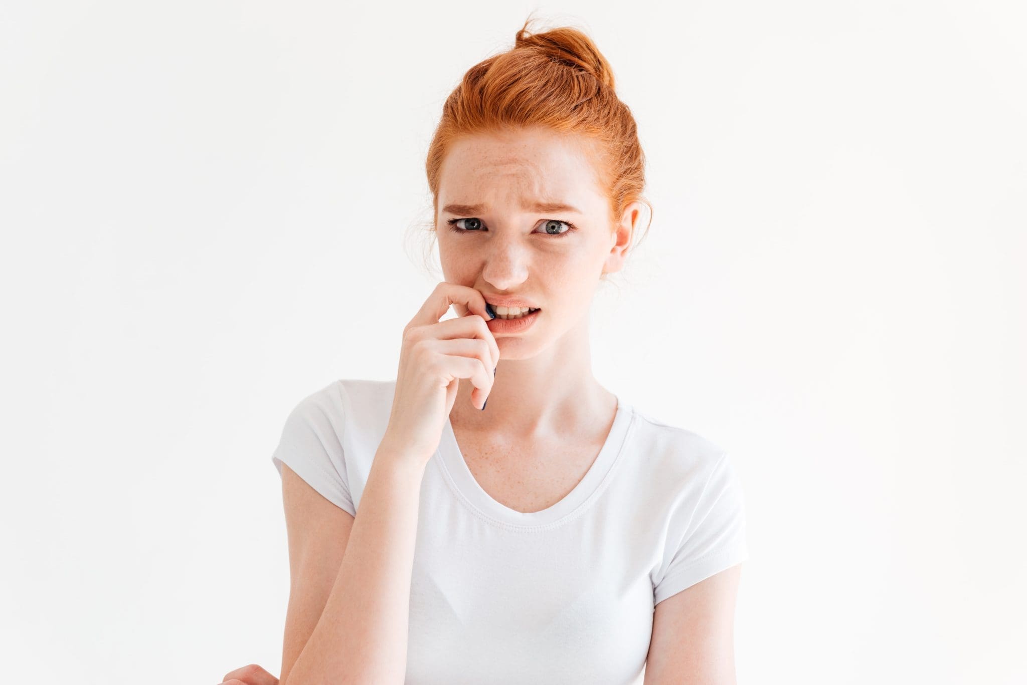 confused-ginger-woman-t-shirt-bites-her-finger-looking-min-scaled